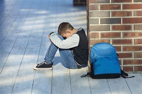 Schoolboy Crying In The Hallway Of The School Stock Photo Download