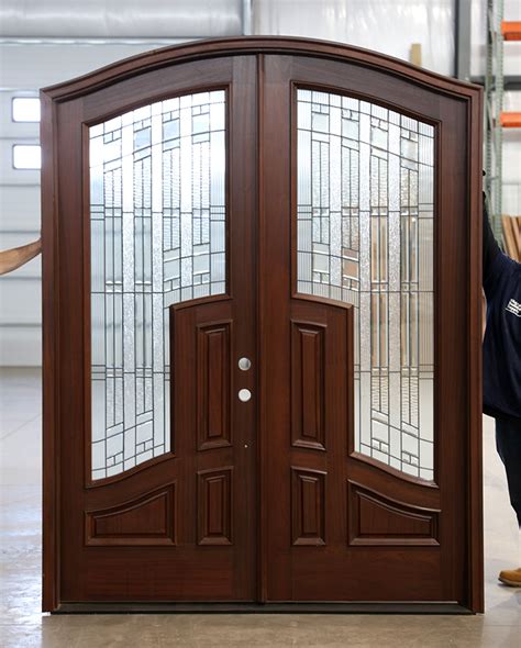 Custom iron front entry doors transform the design of any entrance. Mahogany Arched Top Double Doors