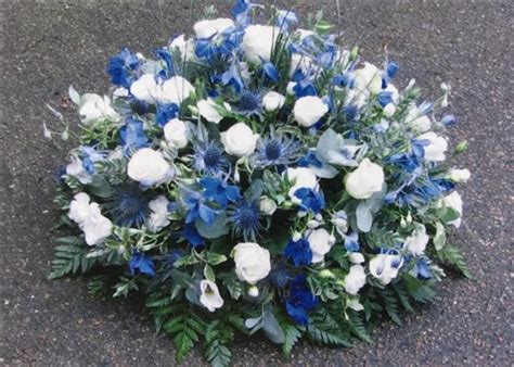 Blue flowers represent peace and serenity. Funeral Flowers - Blue and White Country Posy