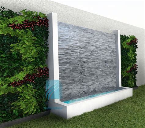A Water Fountain In Front Of A Green Wall