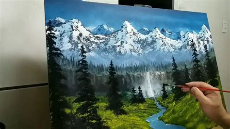 A Person Is Holding A Paintbrush In Their Hand And Painting A Landscape