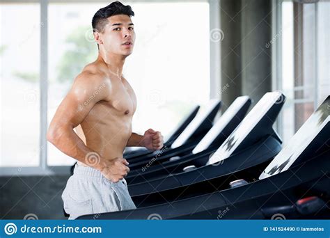 Muscular Bodybuilder Runner Guy Exercise Running On Treadmill In The
