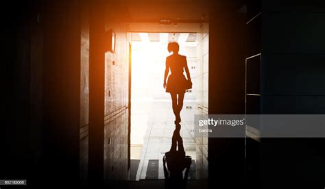 Woman Walking Into The Light High Res Stock Photo Getty Images