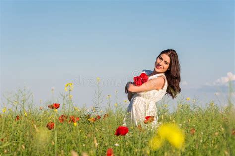 Summer Girl In Poppy Field Holding A Poppies Bouquet Stock Photo