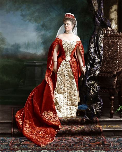A Woman In A Red And White Dress Standing Next To A Chair Wearing A Tiara