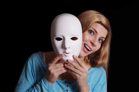 premium photo woman taking off mask