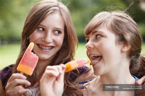 2 Girls Eating Popsicles Together — Enjoyment Smiling Stock Photo