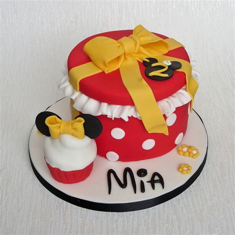 A Birthday Cake Decorated With Mickey Mouse And Minnie Mouse Cupcakes
