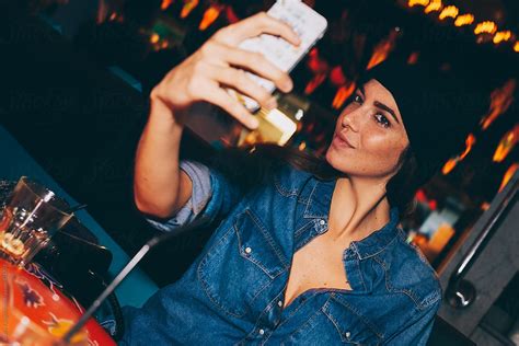 Girl In Bar Taking Selfie By Stocksy Contributor Guille Faingold