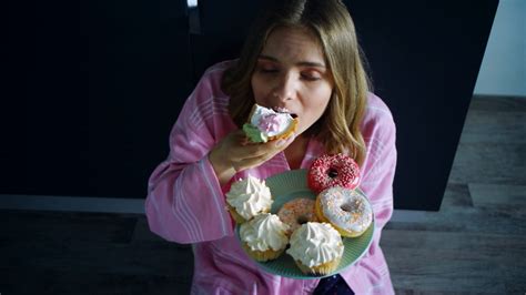Woman Overeat Sweet Cupcake On Kitchen Table Hungry Woman Eating