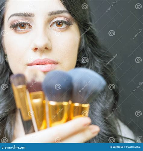 Beautiful Woman At Beauty Salon With Set Of Makeup Brushes Stock Photo