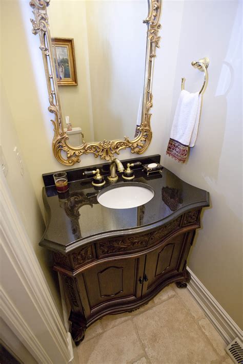 Black granite vanity top with gold framed mirror ...