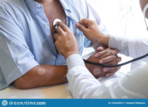 Doctor Using Stethoscope To Listen Checking Heart Rate Measuring To A
