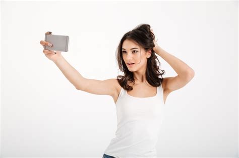 free photo portrait of a sensual woman dressed in tank top taking a selfie