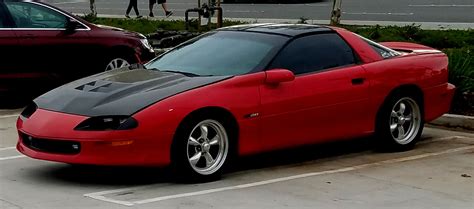 A Red Sports Car Parked In A Parking Lot