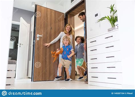 Family entering the house stock photo. Image of entering 