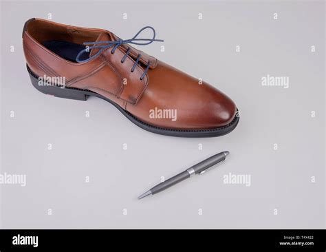 Business Shoe Brown With Ballpoint Pen Stock Photo Alamy