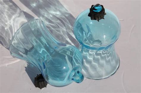 Slender glass hurricane candle holders are a great way to make a beautiful candle display. pale blue candle glasses, hand-blown glass hurricane ...
