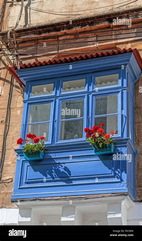 Blue Balcony With Red Flowers Stock Photo Alamy