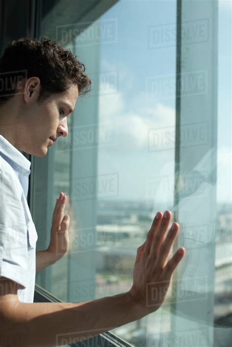 Man Looking Out Of Window Side View Stock Photo Dissolve