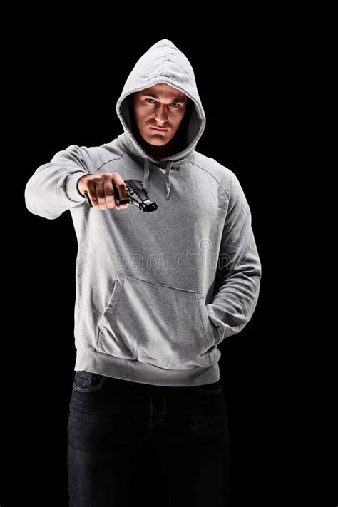 Young Man With Hood Over His Head Holding A Gun ...