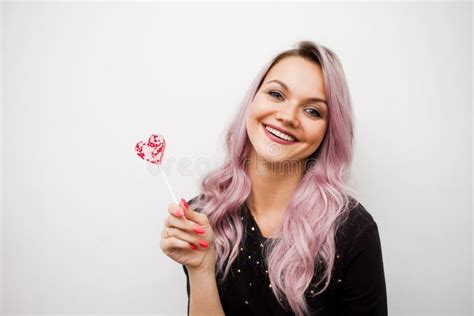 Lovely Charming Girl With A Lollipop In The Form Of Heart Portrait Of