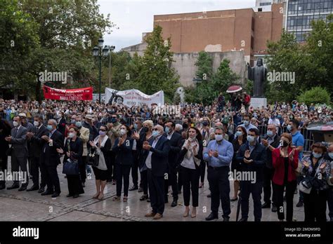 People clap hands as they attend a farewell ceremony for the late Greek