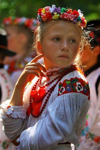 A Young Romania Girl Sporting A Brightly Hued Traditional Folk Costume