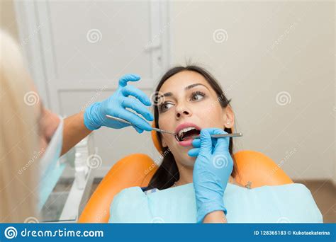 Pretty Girl Having Mouth Checkup In Hospital By Professional Female