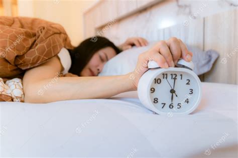 Premium Photo Alarm Clock That Wakes Up In The Morning In The Bedroom