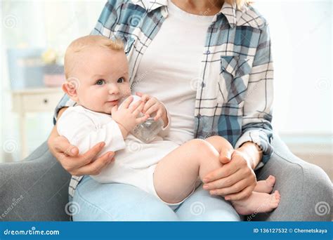 Lovely Mother Giving Her Baby Drink From Bottle Stock Photo Image Of