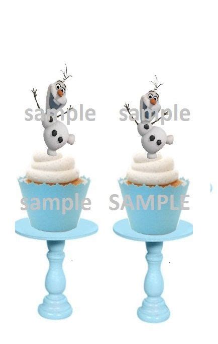 Two Cupcakes With Frosting On Them Sitting On Top Of Blue Pedestals