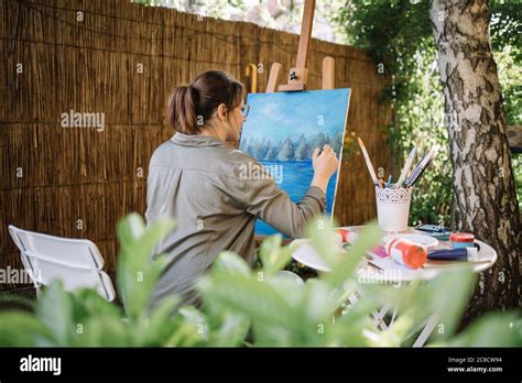 Back Of Female Artist Painting With Paintbrush Stock Photo Alamy