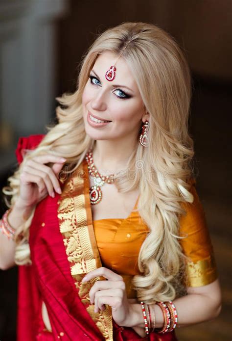 Beautiful Blonde Girl In Indian Red Saree Around The Christmas T Stock