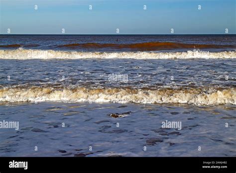A View Of Waves Breaking And Rolling To Shore On The Norfolk Coast At