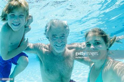 Grandpa And Grandson In Pool Photos And Premium High Res Pictures