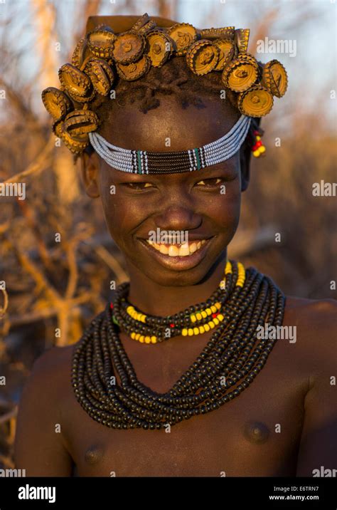 Portrait Of A Young Dassanech Girl Wearing Bottle Caps Headgear And