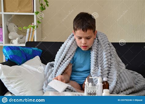Sick Child Boy Lying In Bed With A Fever Resting At Home A Boy With A