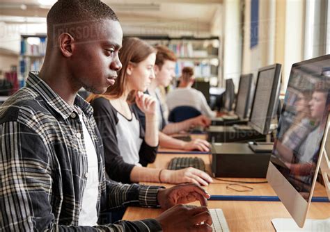 Group Of Students Using Computers In College Library Stock Photo