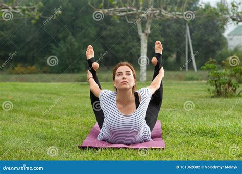 Young Beautiful Woman Doing Yoga Exercise In Green Park Healthy Lifestyle And Fitness Concept