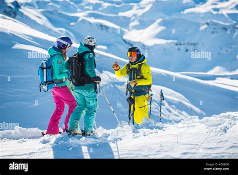 A Ski Instructor Guides Two Women Off Piste In The French Ski Resort Of