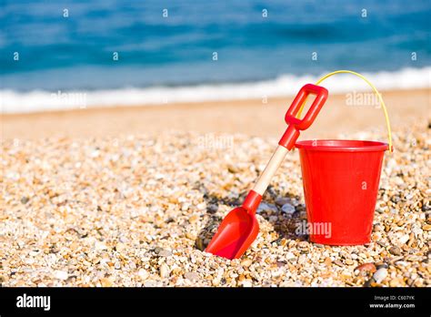 Red Childrens Toy Bucket And Spade On The Beach Stock Photo Alamy