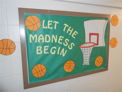 A Sign That Says Let The Madness Begin With Basketballs And Hoop On It