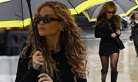 Rita Ora Puts On A Leggy Display In A Lbd As She Shelters From The Rain