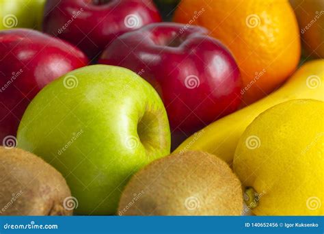 Red Green Apples With Ripe Bananas And Kiwi Orange Lemon On A White