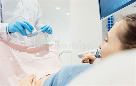 Gynecologist Attempting Ultrasonic Examination Of Patient Stock Image
