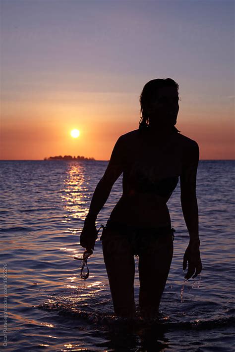 Beautiful Woman Having A Bath During A Sunset In A Tropical Deserted