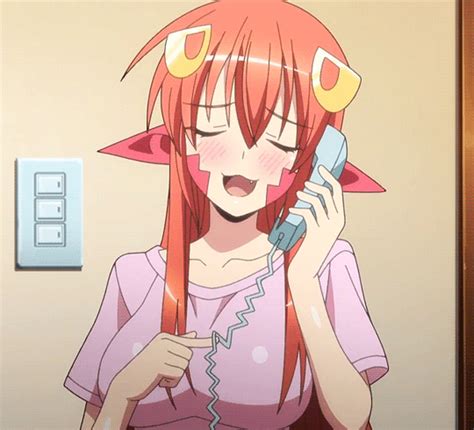 A Girl With Pink Hair Talking On A Cell Phone Next To A Light Switch Box