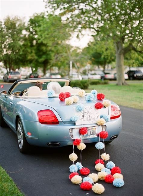 Cute Getaway wedding car with Pom poms | Wedding car decorations
