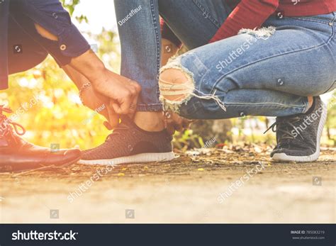 Boyfriend Helping Girlfriend Wearing Shoe Park Stock Photo 785083219